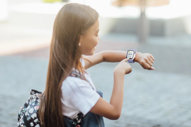 A girl wearing a Fone S4 smartwatch