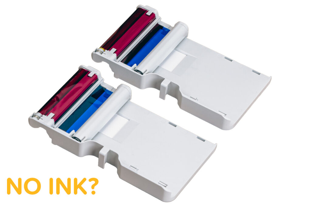 Two dye sublimation film cartridges against a white background labeled "No ink?"