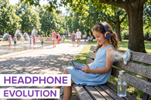 A little girl wearing CareBuds Max in August in the park while it's hot out
